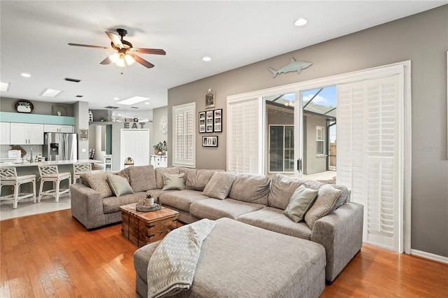 living area featuring recessed lighting, light wood-type flooring, and ceiling fan