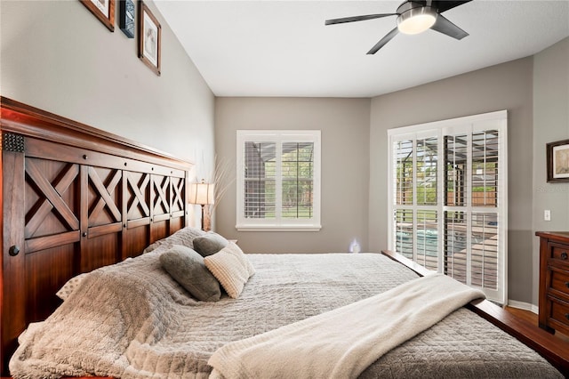 bedroom with a ceiling fan, baseboards, and wood finished floors