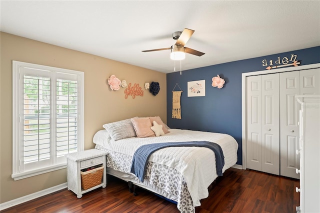 bedroom with dark wood finished floors, baseboards, and a closet