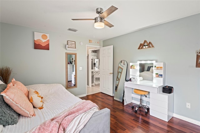 bedroom with visible vents, a ceiling fan, wood finished floors, stainless steel fridge with ice dispenser, and baseboards