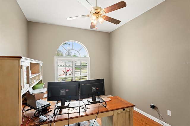 home office featuring a ceiling fan, light wood-style floors, and baseboards