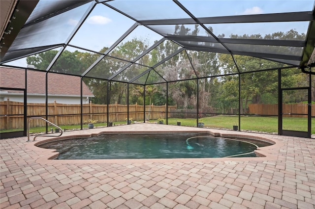 view of swimming pool featuring a patio, a fenced backyard, and a lanai