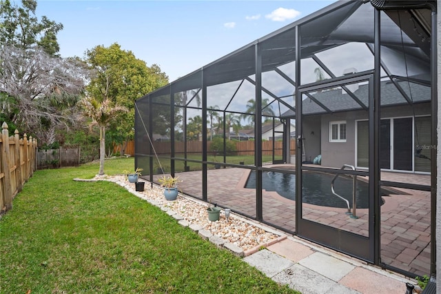 view of yard with glass enclosure, a patio, a fenced backyard, and a fenced in pool