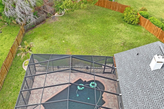 view of yard featuring a lanai, a fenced backyard, and a patio area