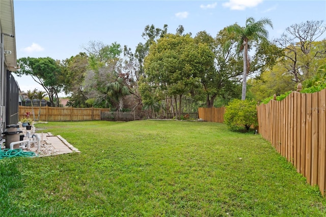 view of yard with a fenced backyard