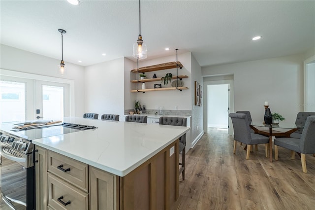 kitchen featuring wood finished floors, open shelves, recessed lighting, stainless steel range with electric cooktop, and french doors