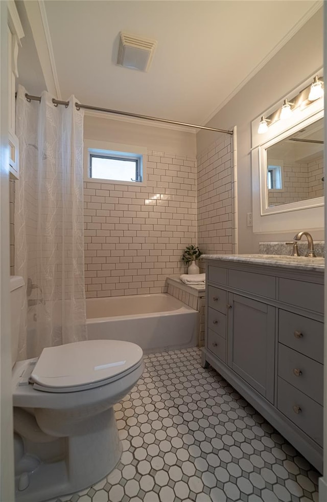 bathroom with vanity, toilet, ornamental molding, and shower / bath combo