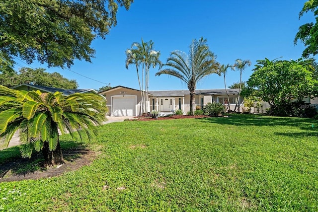 ranch-style home with a front lawn, concrete driveway, a garage, and stucco siding