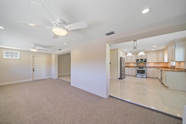 unfurnished living room featuring visible vents, a sink, a textured ceiling, recessed lighting, and ceiling fan