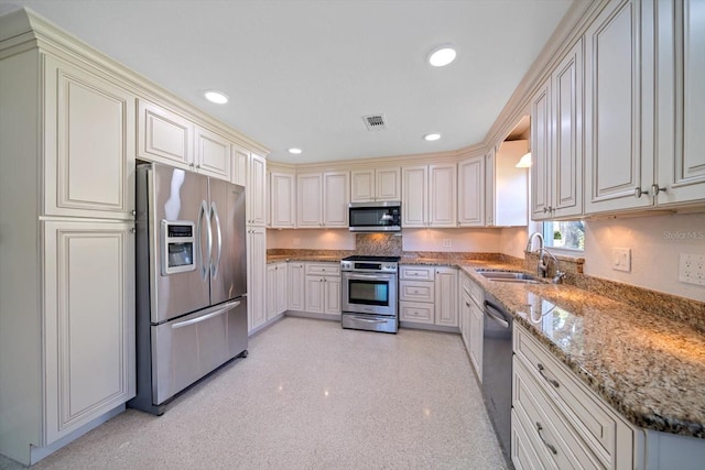 kitchen featuring visible vents, a sink, recessed lighting, appliances with stainless steel finishes, and light stone countertops