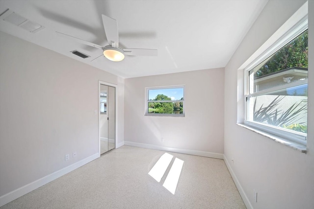 unfurnished room featuring visible vents, baseboards, and a ceiling fan