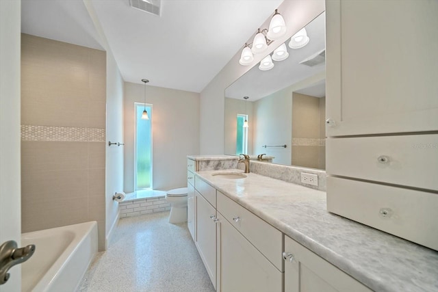 bathroom with vanity, toilet, a tub to relax in, and visible vents