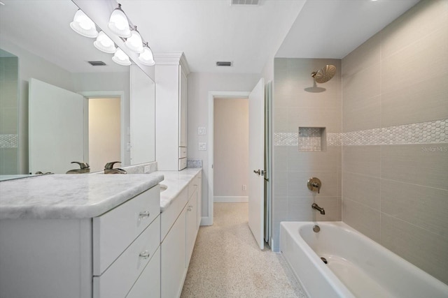 full bathroom with vanity, speckled floor, visible vents, and shower / bathtub combination