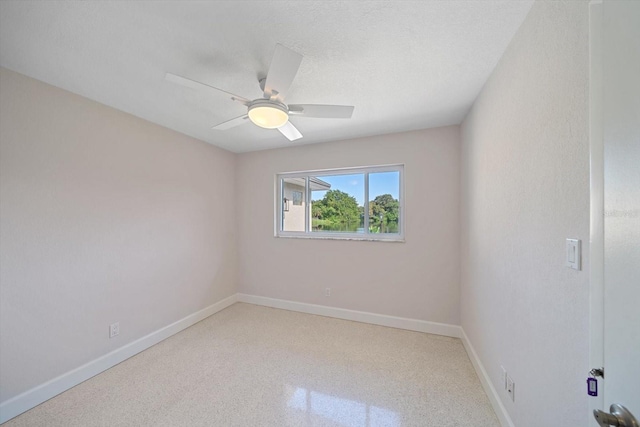 unfurnished room with a ceiling fan, baseboards, and a textured ceiling