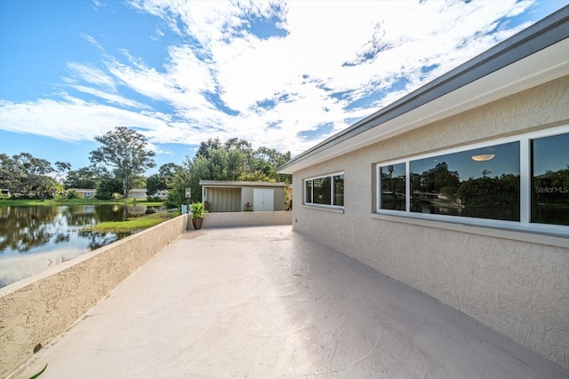 exterior space with an outdoor structure and a water view