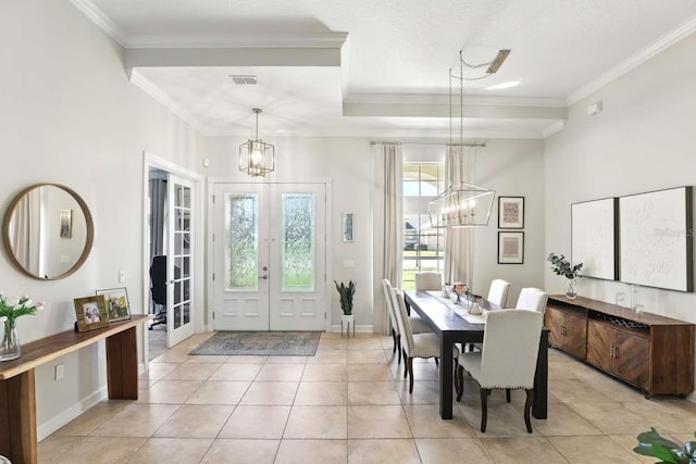 foyer entrance with visible vents, an inviting chandelier, crown molding, and french doors