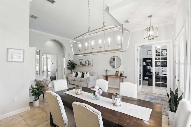 dining space featuring visible vents, ornamental molding, light tile patterned floors, an inviting chandelier, and arched walkways