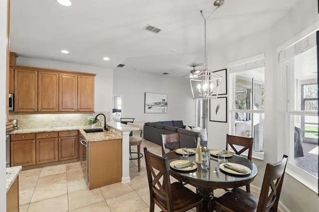 dining area featuring light tile patterned floors, visible vents, baseboards, recessed lighting, and a notable chandelier