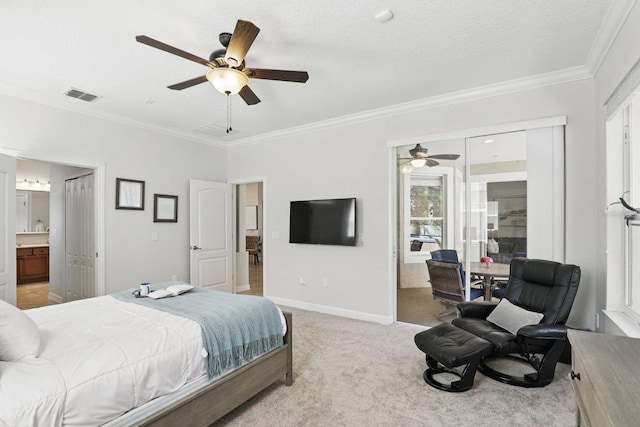 bedroom featuring visible vents, baseboards, ornamental molding, light carpet, and ensuite bathroom