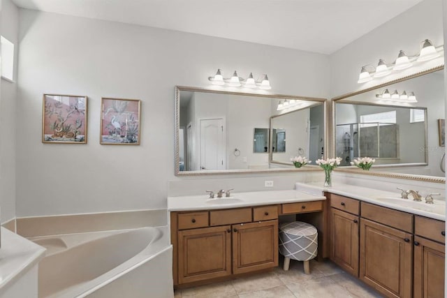 bathroom with two vanities, a shower stall, a bath, and a sink