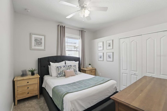 bedroom featuring a textured ceiling, carpet flooring, a closet, and ceiling fan