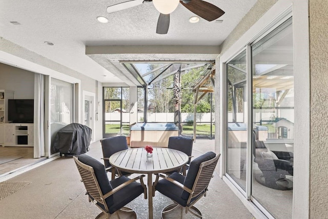 sunroom / solarium with a ceiling fan