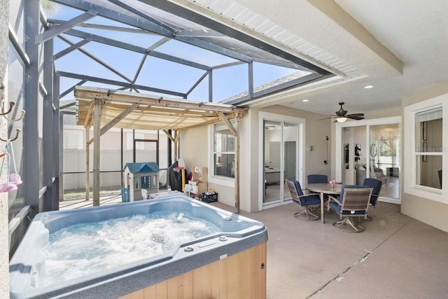 view of patio / terrace featuring a lanai and a hot tub