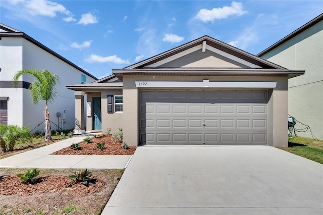 ranch-style home featuring stucco siding, a garage, and concrete driveway