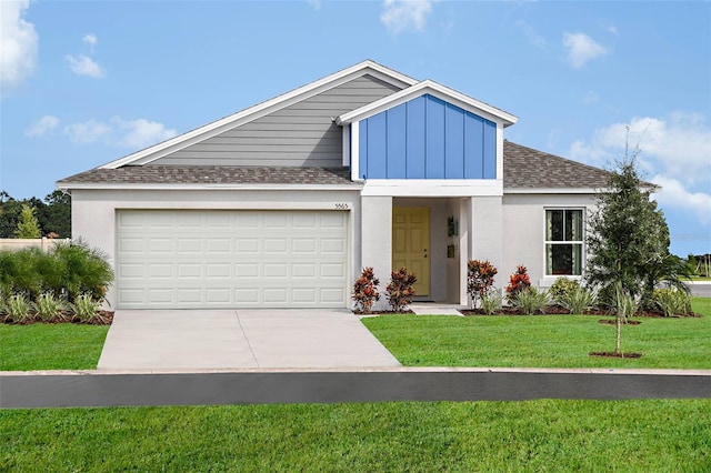 view of front facade featuring driveway, board and batten siding, roof with shingles, a front yard, and a garage