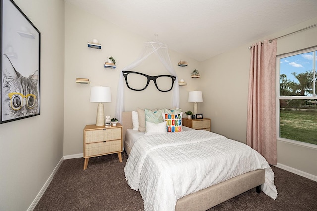 bedroom with dark carpet and baseboards