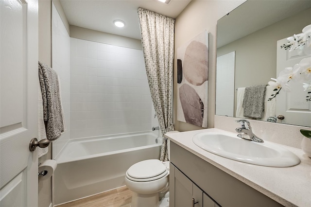 bathroom featuring shower / bathtub combination with curtain, toilet, wood finished floors, and vanity