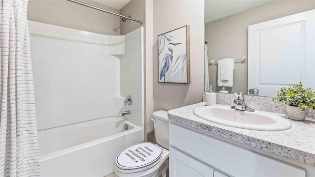 bathroom featuring vanity, shower / tub combo, and toilet