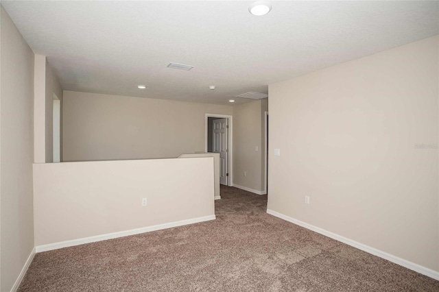 unfurnished room featuring recessed lighting, carpet flooring, visible vents, and baseboards