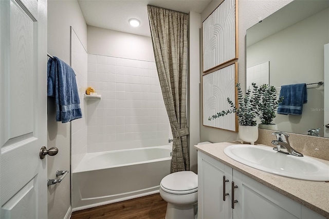 bathroom featuring vanity, toilet, shower / bath combo with shower curtain, and wood finished floors