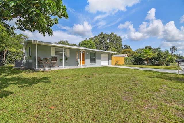 ranch-style home featuring a front lawn, a porch, a garage, and driveway