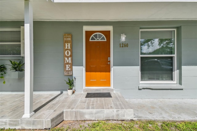 view of exterior entry featuring covered porch