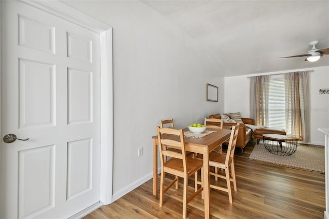 dining room with baseboards, ceiling fan, and wood finished floors