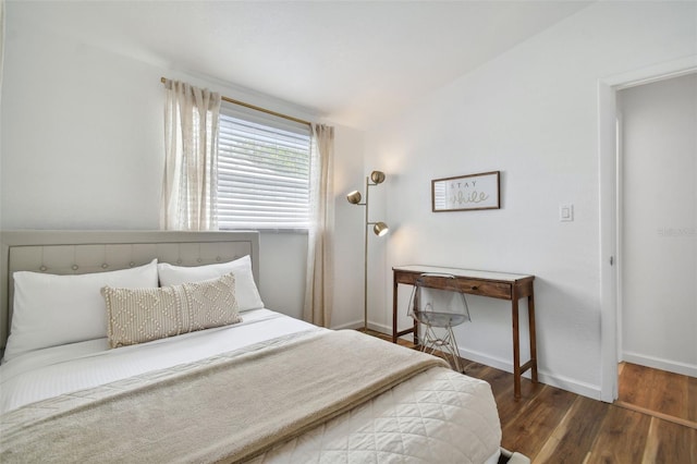 bedroom featuring baseboards and wood finished floors