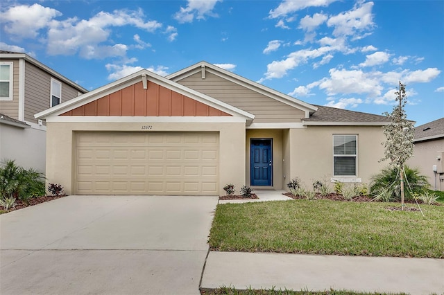 ranch-style house featuring a front yard, concrete driveway, a garage, and stucco siding