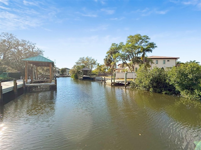 view of dock featuring a gazebo and a water view