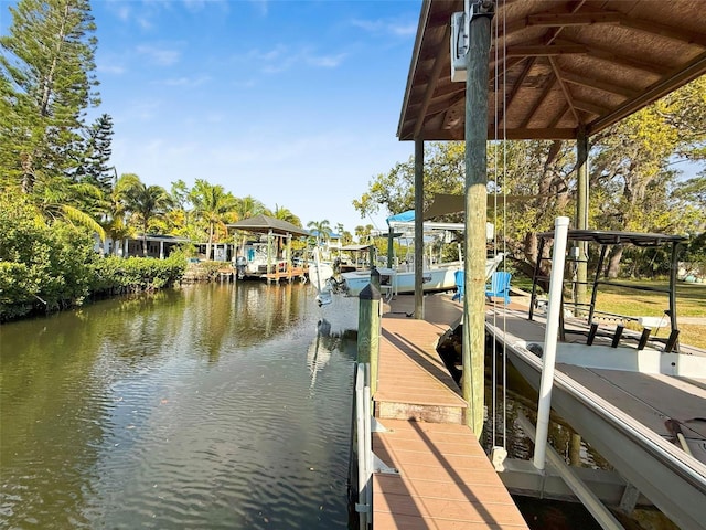 view of dock featuring a water view and boat lift