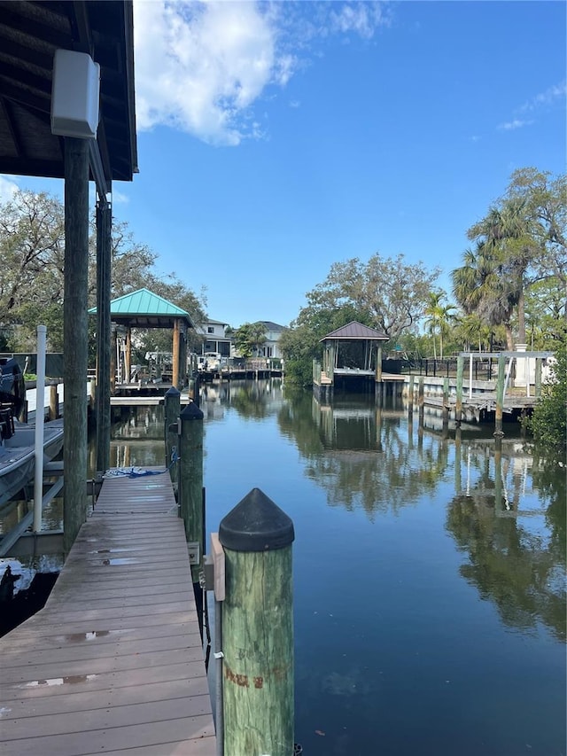 view of dock featuring a gazebo and a water view