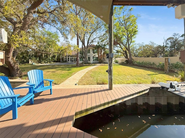 dock area featuring a lawn, a wooden deck, and fence