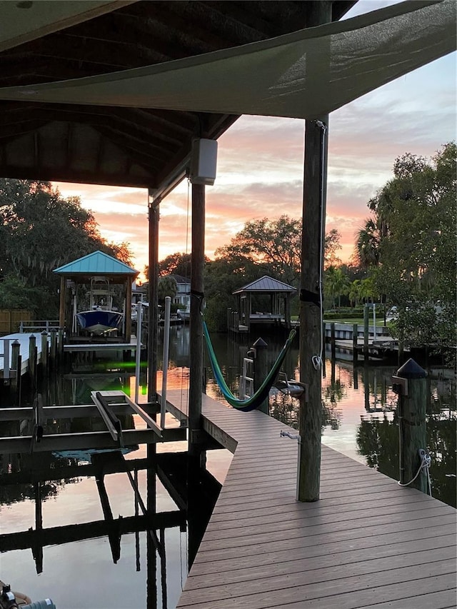 view of dock featuring boat lift and a water view