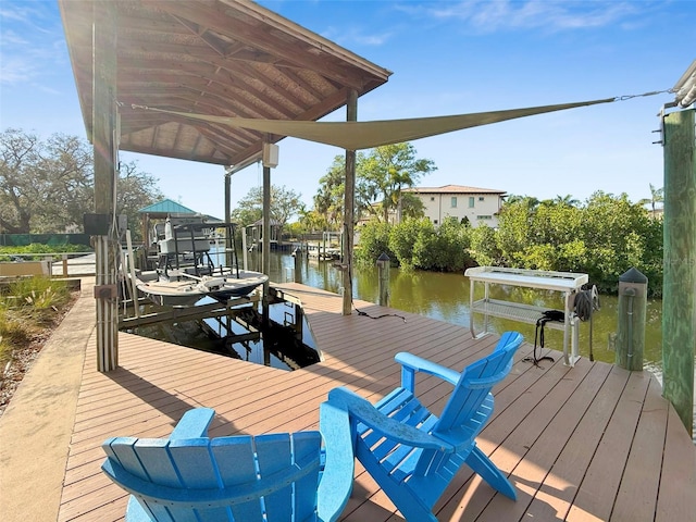 dock area with boat lift and a water view