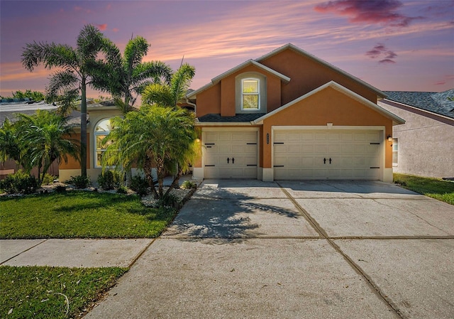 7116 Colonial Lake Dr, Riverview, FL 33578 - view of front of property with stucco siding, driveway, a yard, and a garage