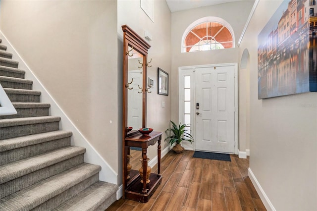 7116 Colonial Lake Dr, Riverview, FL 33578 - foyer entrance with stairs, dark wood finished floors, baseboards, a towering ceiling, and arched walkways