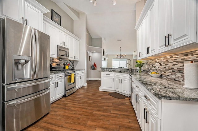 7116 Colonial Lake Dr, Riverview, FL 33578 - kitchen featuring stainless steel appliances, a peninsula, white cabinets, and decorative backsplash