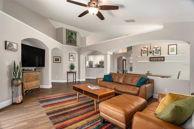 7116 Colonial Lake Dr, Riverview, FL 33578 - living room with arched walkways, ceiling fan, wood finished floors, vaulted ceiling, and baseboards