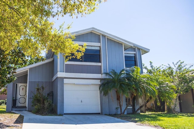 view of front of house with a front yard, a garage, and driveway